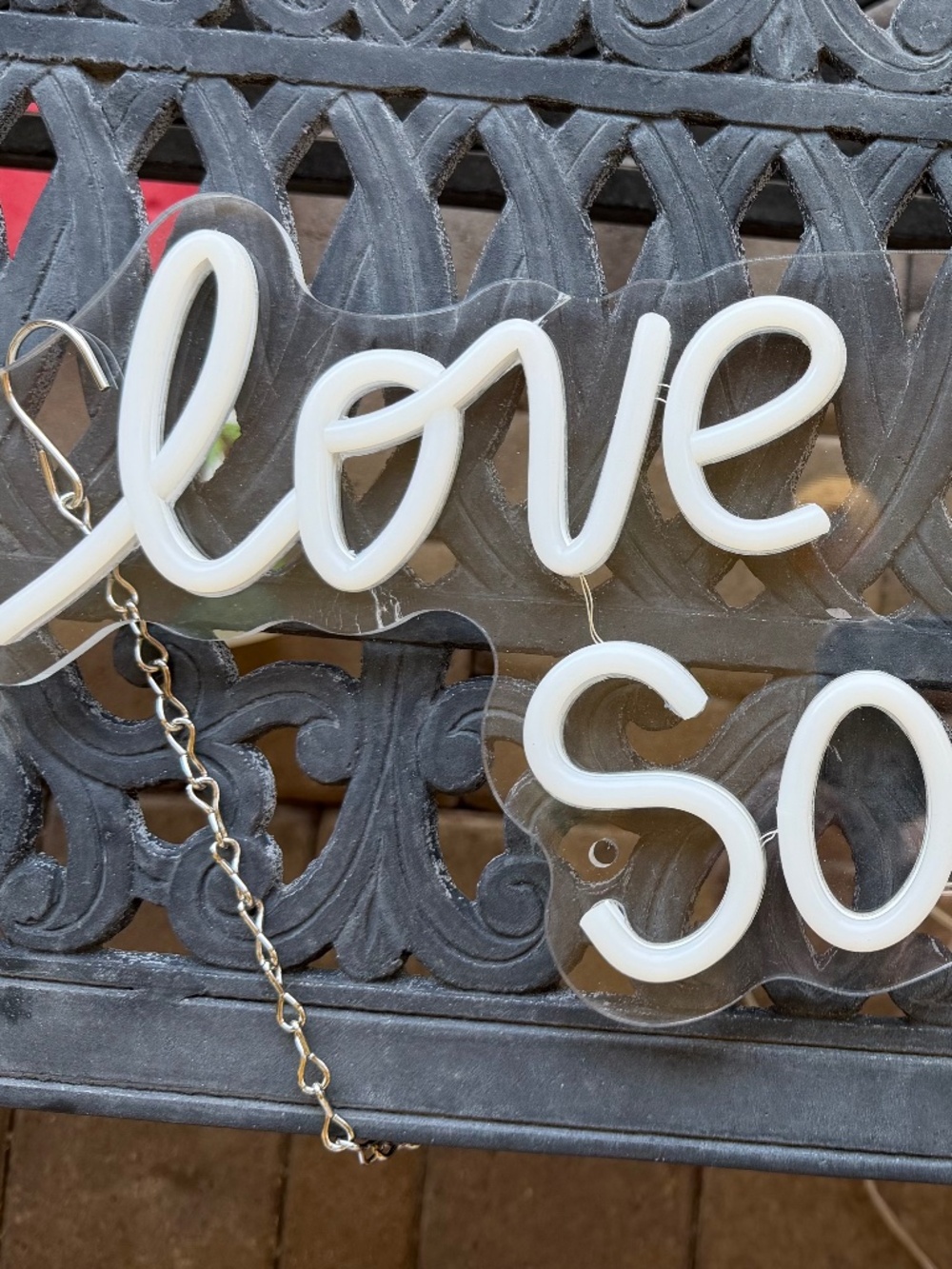 Wedding decorations - neon sign, flower vases, candles, and sparkles